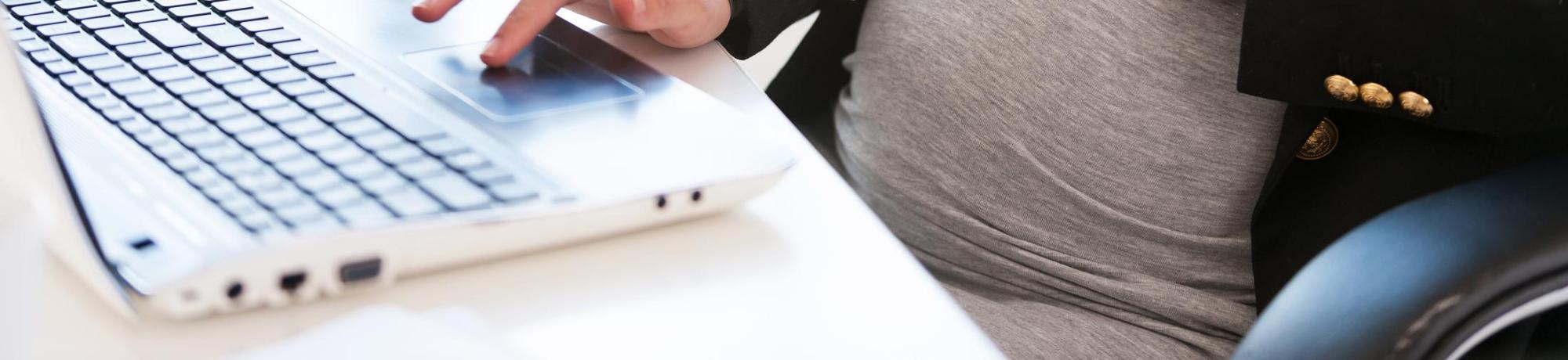 Pregnant woman using her laptop